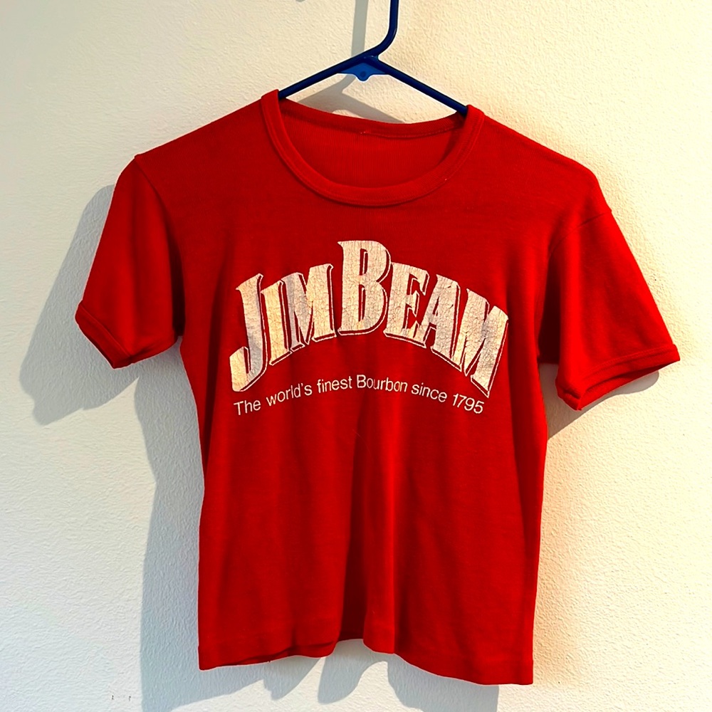 Jim Beam semi crop depending on bust and torso length. Sits at top of jeans